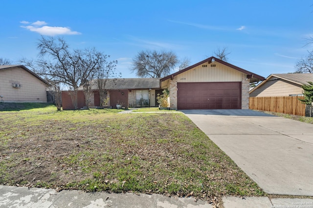 ranch-style home featuring a garage and a front lawn