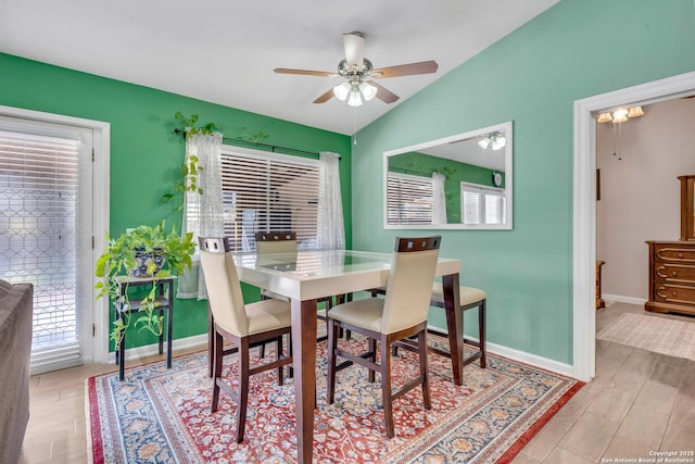 dining space featuring lofted ceiling, plenty of natural light, ceiling fan, and light wood-type flooring