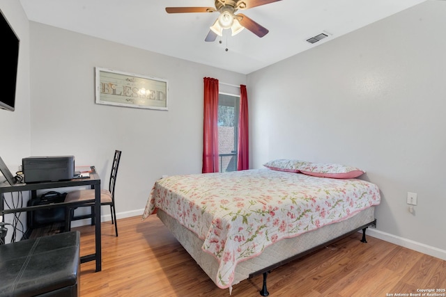 bedroom with ceiling fan and light hardwood / wood-style flooring