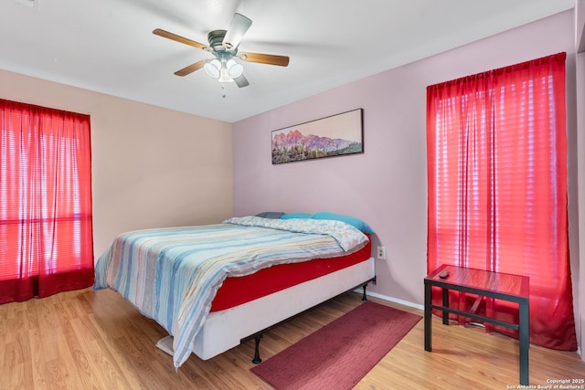 bedroom with ceiling fan and hardwood / wood-style floors