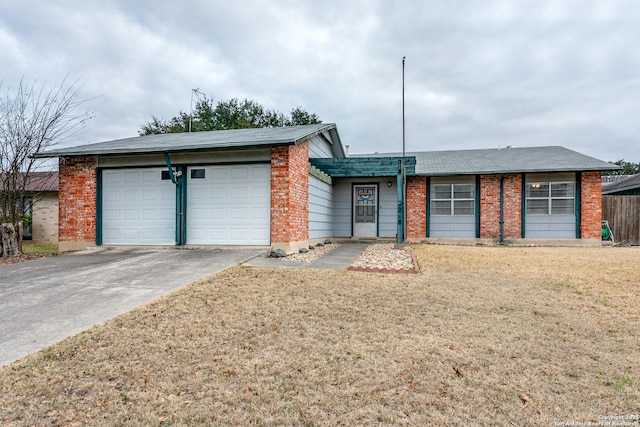 ranch-style house featuring a garage and a front lawn