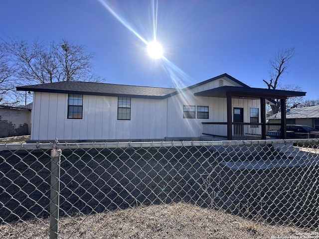 back of property with a porch