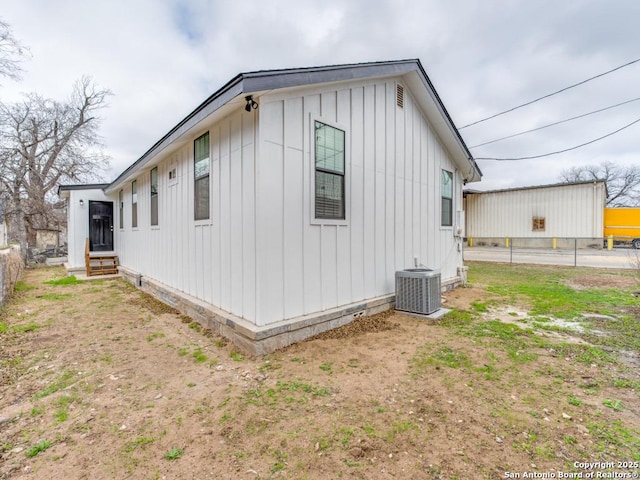 view of side of home with central AC