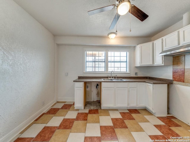 kitchen featuring white cabinetry, sink, a textured ceiling, and ceiling fan