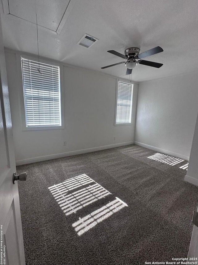 unfurnished room with a textured ceiling, ceiling fan, and carpet flooring