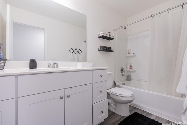 full bathroom with shower / tub combo, vanity, hardwood / wood-style flooring, and toilet