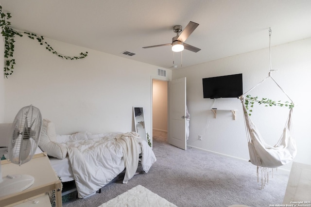 bedroom with ceiling fan and light carpet