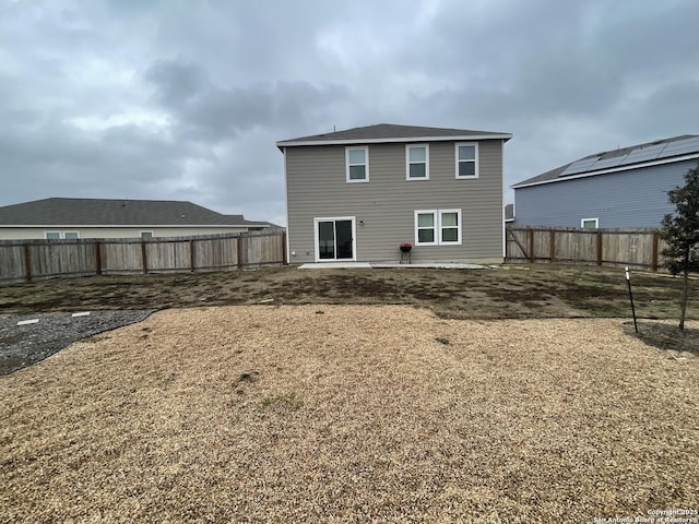 back of house featuring a yard and a patio area