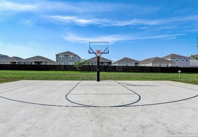 view of basketball court featuring a yard