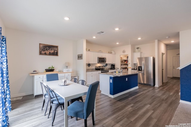 dining room featuring dark hardwood / wood-style floors and sink