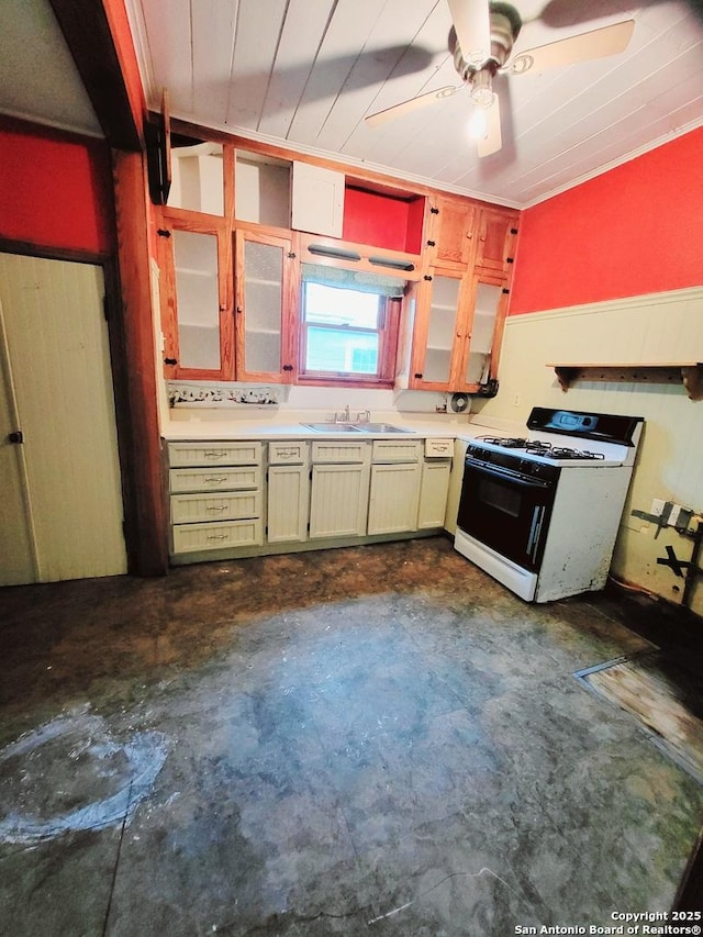 kitchen with ceiling fan, white gas range, and sink