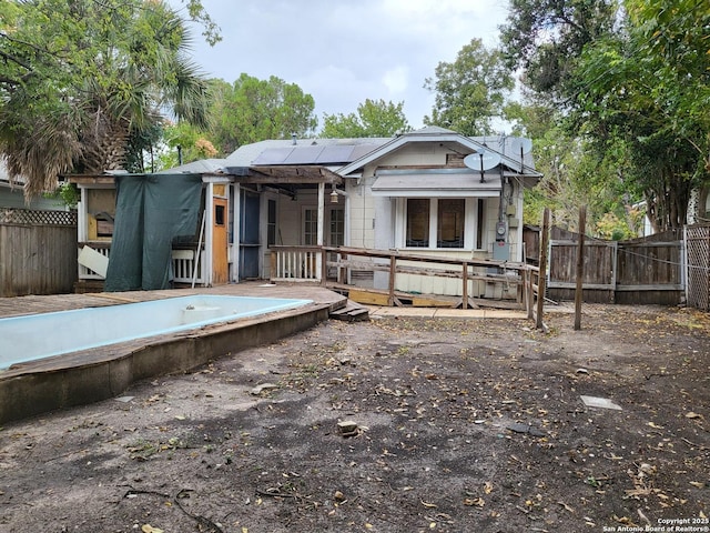 back of property featuring solar panels