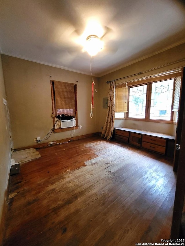 unfurnished room featuring wood-type flooring, cooling unit, and crown molding