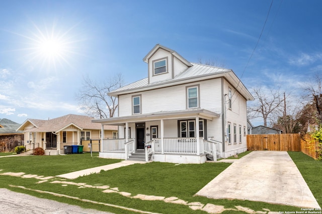 view of front of house with covered porch and a front lawn