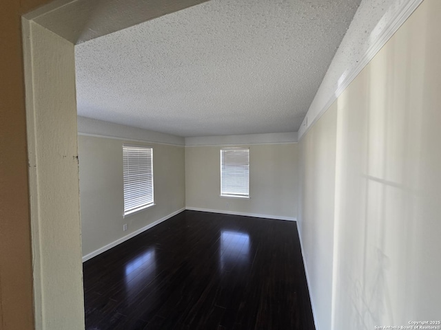 spare room with hardwood / wood-style flooring and a textured ceiling