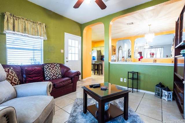 tiled living room featuring ceiling fan