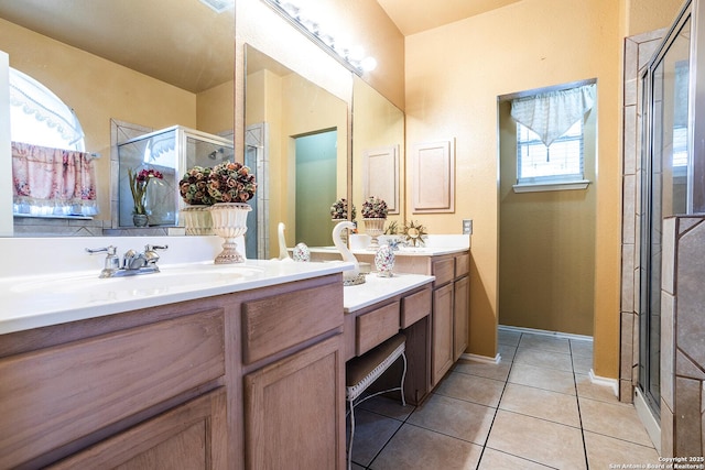 bathroom with vanity, a shower with door, and tile patterned flooring