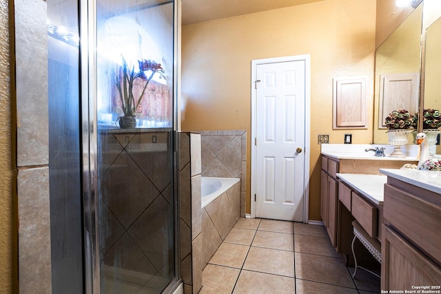 bathroom featuring vanity, independent shower and bath, and tile patterned flooring