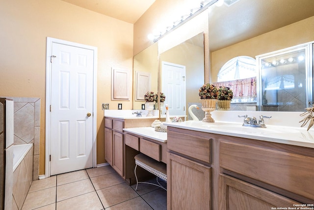 bathroom featuring vanity, a washtub, and tile patterned floors