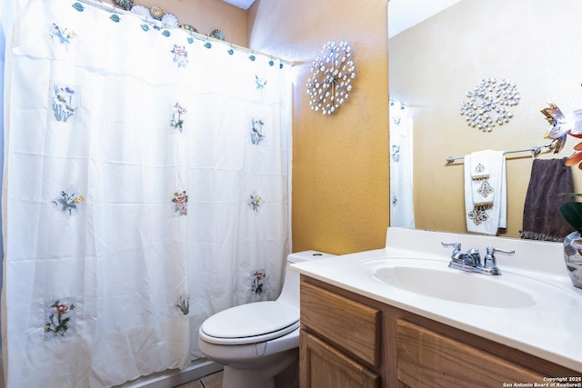 bathroom featuring vanity, curtained shower, and toilet