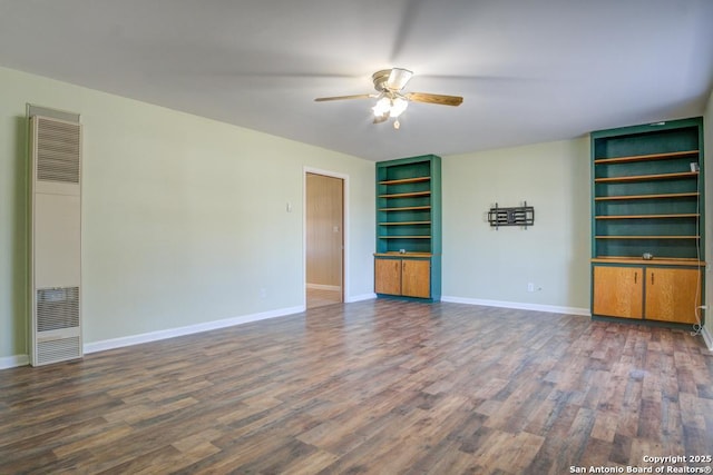 spare room with dark wood-type flooring and ceiling fan