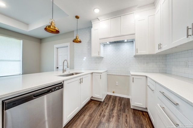 kitchen featuring white cabinetry, sink, decorative light fixtures, and dishwasher