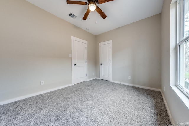 empty room with ceiling fan and carpet flooring