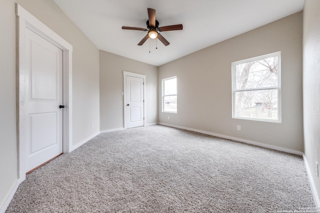 carpeted spare room with ceiling fan