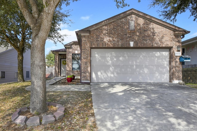 view of front of property with a garage, concrete driveway, and brick siding