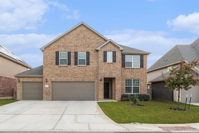 view of front facade with a garage and a front yard