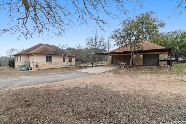 view of side of home featuring a carport and central AC unit