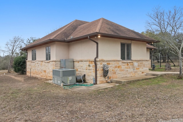 view of property exterior with central AC