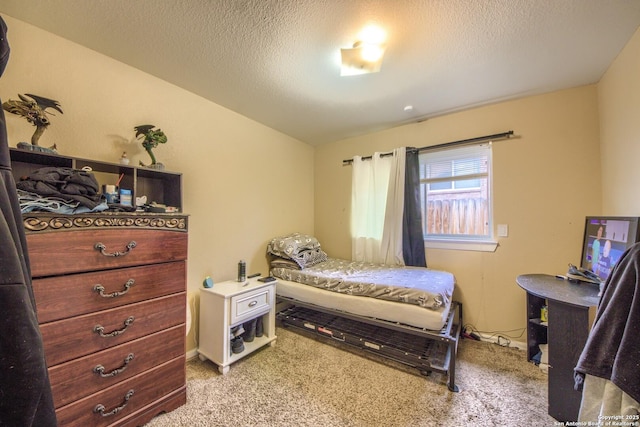 bedroom featuring vaulted ceiling, light carpet, and a textured ceiling