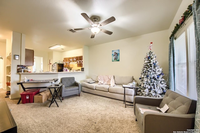 carpeted living room featuring ceiling fan