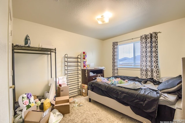 bedroom with carpet and a textured ceiling