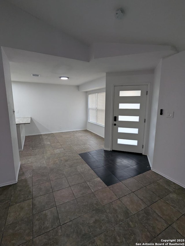 entryway with dark tile patterned flooring