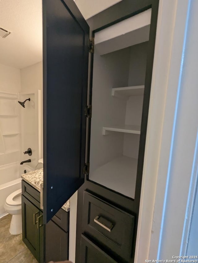 full bathroom featuring vanity, tub / shower combination, and toilet