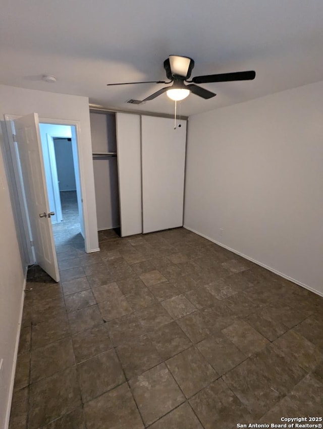 unfurnished bedroom with a closet and ceiling fan