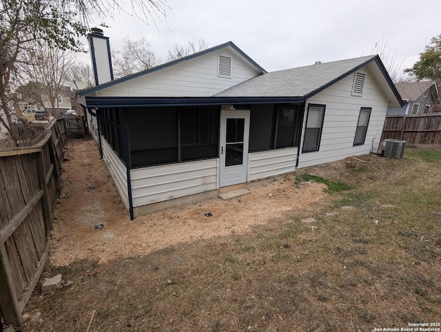 rear view of house featuring a sunroom and central air condition unit