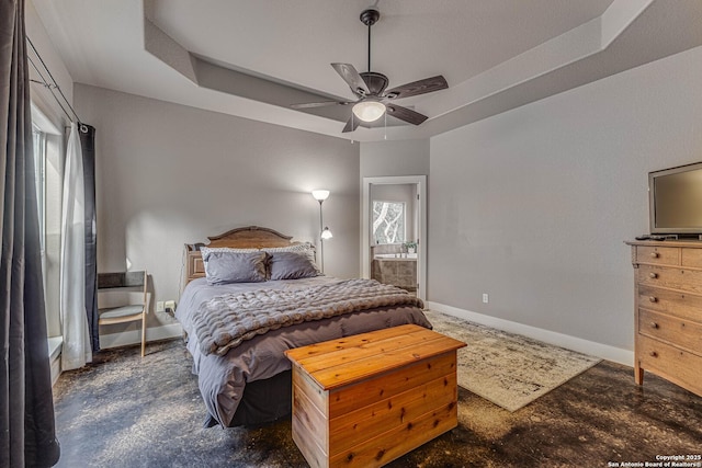 bedroom featuring ceiling fan and a tray ceiling