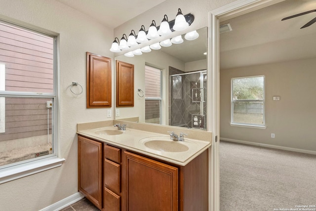 bathroom with ceiling fan, vanity, and a shower with shower door