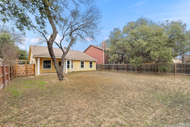 back of house featuring a yard