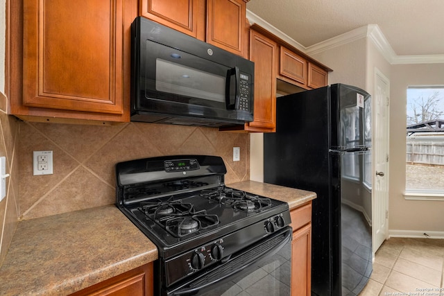 kitchen with tasteful backsplash, light tile patterned floors, ornamental molding, and black appliances