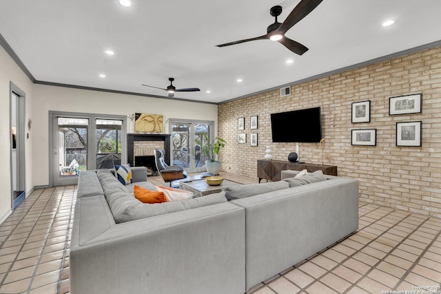 living room with crown molding, ceiling fan, and brick wall