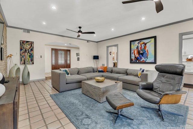 living room with ornamental molding and ceiling fan