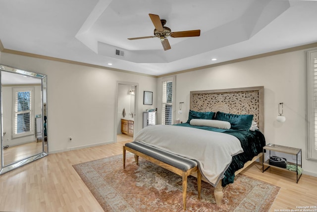 bedroom featuring crown molding, ceiling fan, a raised ceiling, and hardwood / wood-style floors