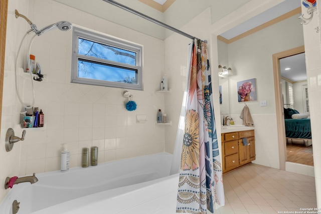 bathroom featuring ornamental molding, vanity, shower / bathtub combination with curtain, and tile patterned flooring