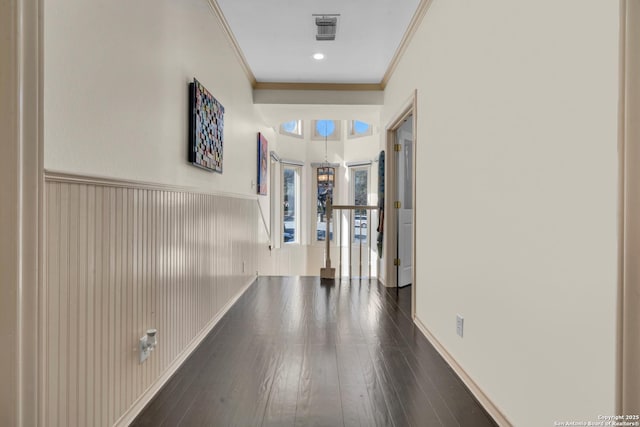 hall with crown molding and dark hardwood / wood-style flooring