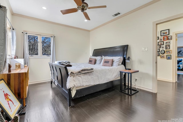 bedroom featuring dark hardwood / wood-style flooring, crown molding, and ceiling fan