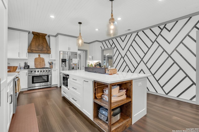 kitchen with premium range hood, a center island, pendant lighting, stainless steel appliances, and white cabinets